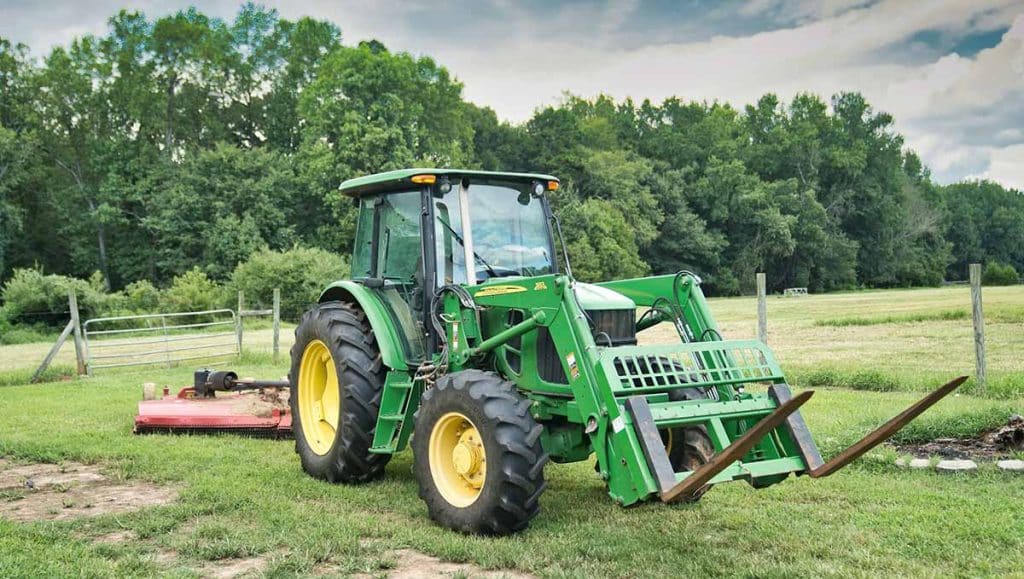 Bush hogging machine clearing property