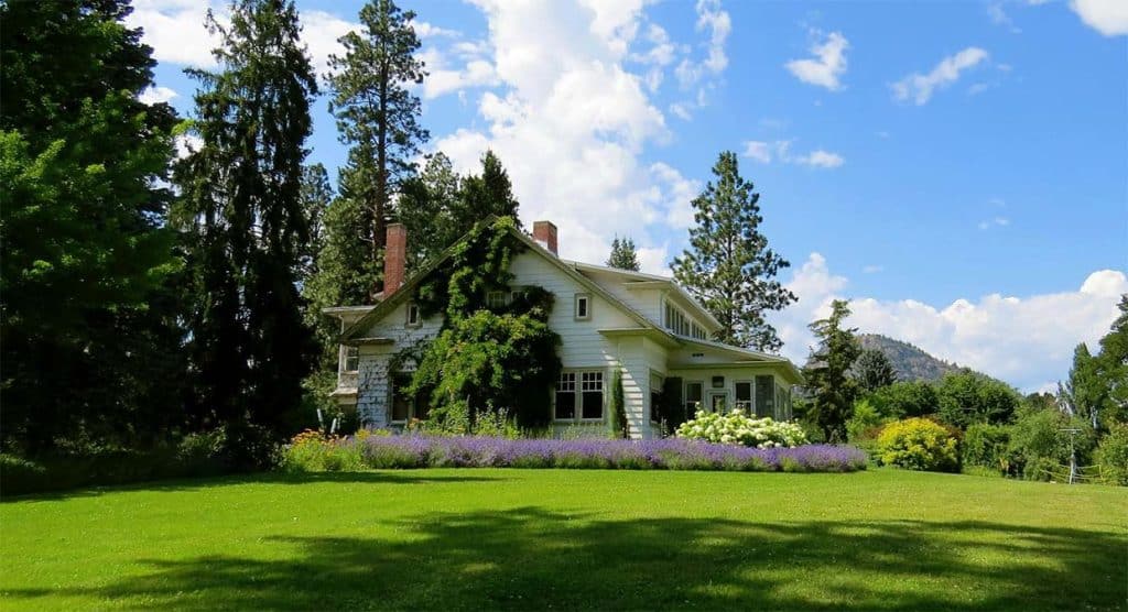 Charming house surrounded by trees and flowers